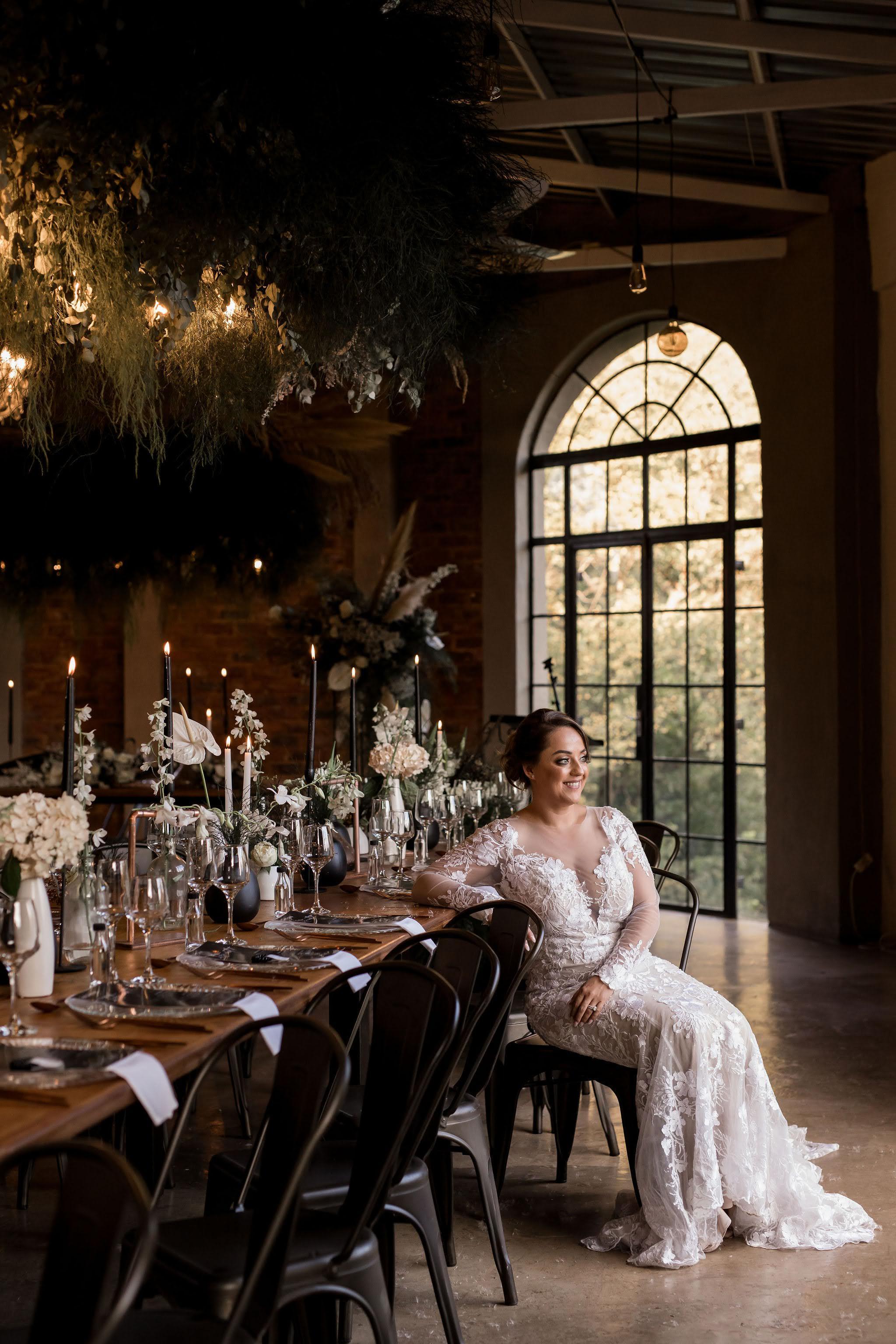 Bride sitting by guest tables