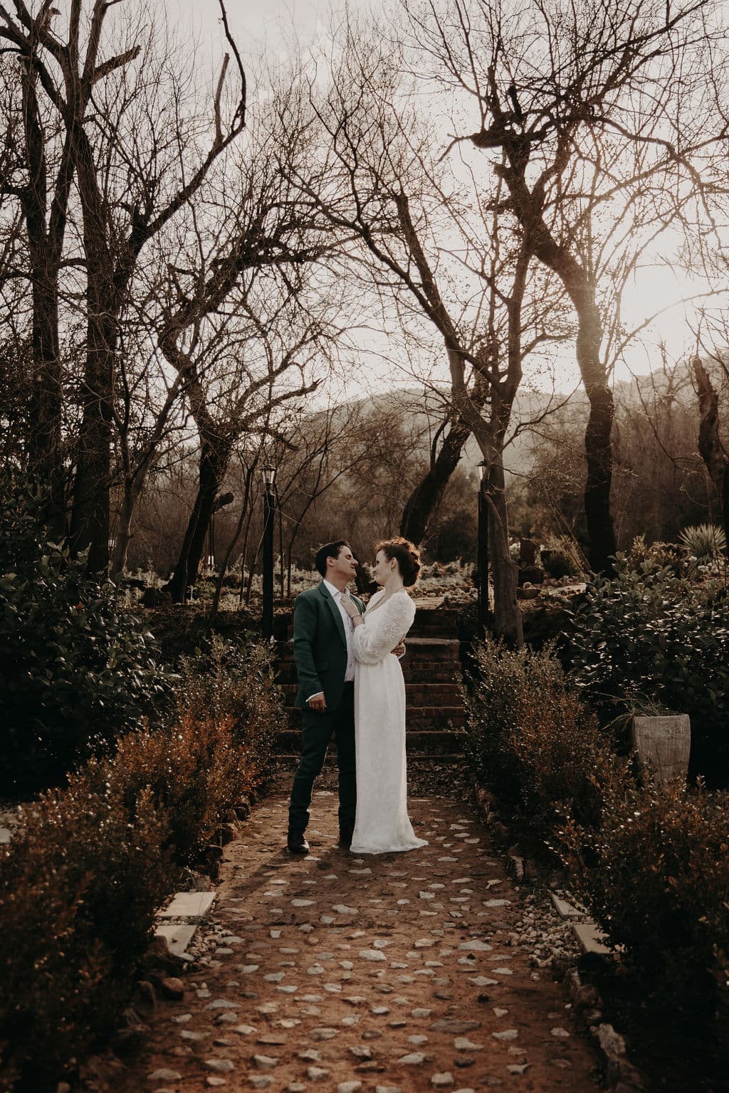 Bridal couple outside in front of stepsChandelier